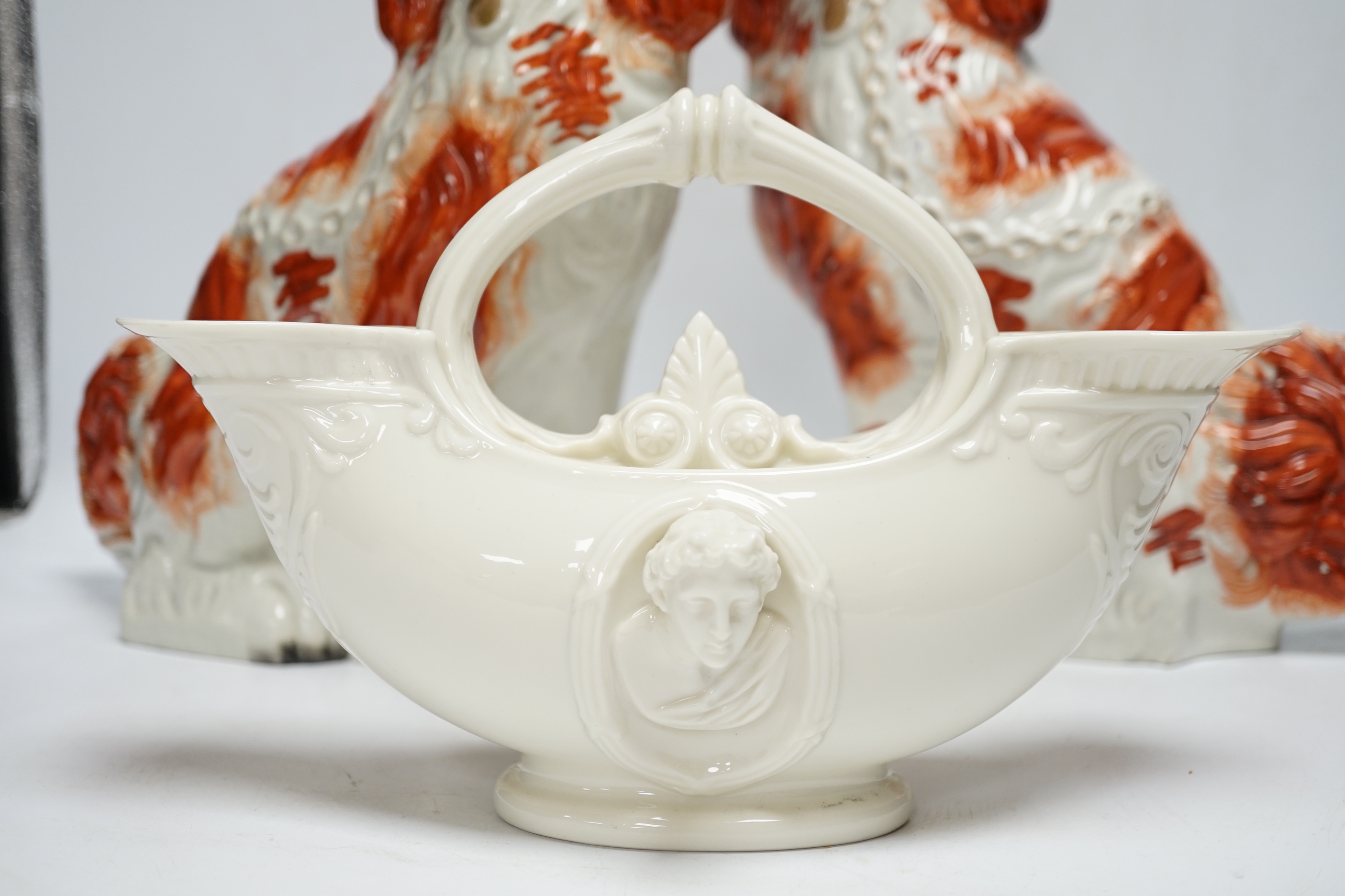 A Royal Worcester classical revival glazed Parian vase and two Staffordshire dogs, 30cm